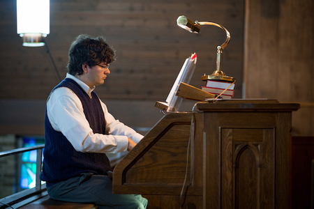 Sacred Music Student Playing Organ At A Local Church